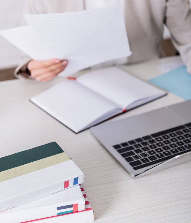 vistacreate-437809990-stock-photo-cropped-view-translator-holding-documents-scaled.jpeg